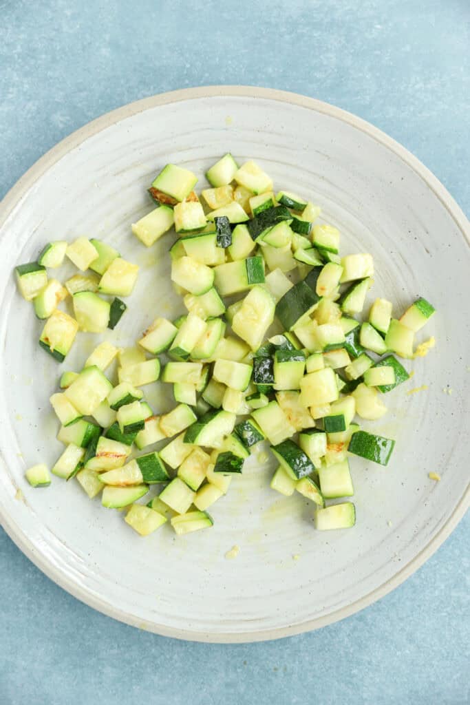 overhead photo of cooked zucchini on a plate.