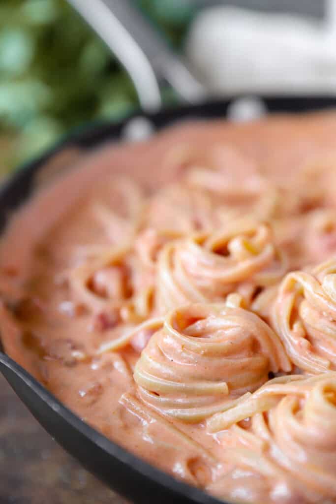 close photo of one of the spiraled linguini noodles  in a nonstick pan.