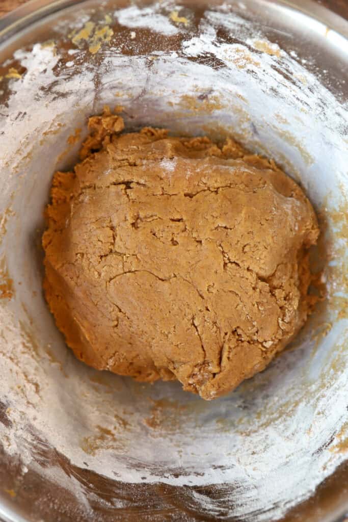 overhead photo of the pumpkin cookie dough in a stainless steel bowl.