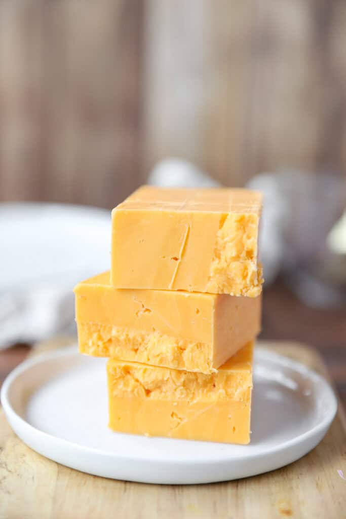 stack of blocks of sharp Cheddar cheese.