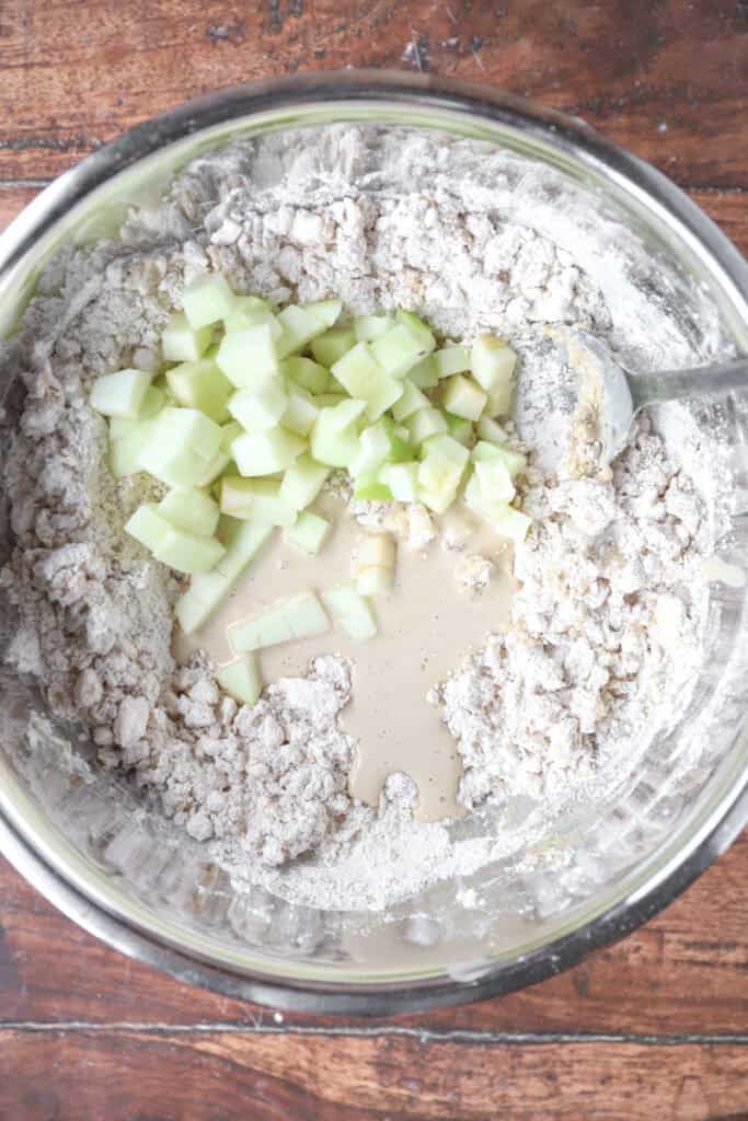 overhead photo of the dry and wet ingredients in a stainless steel bowl.