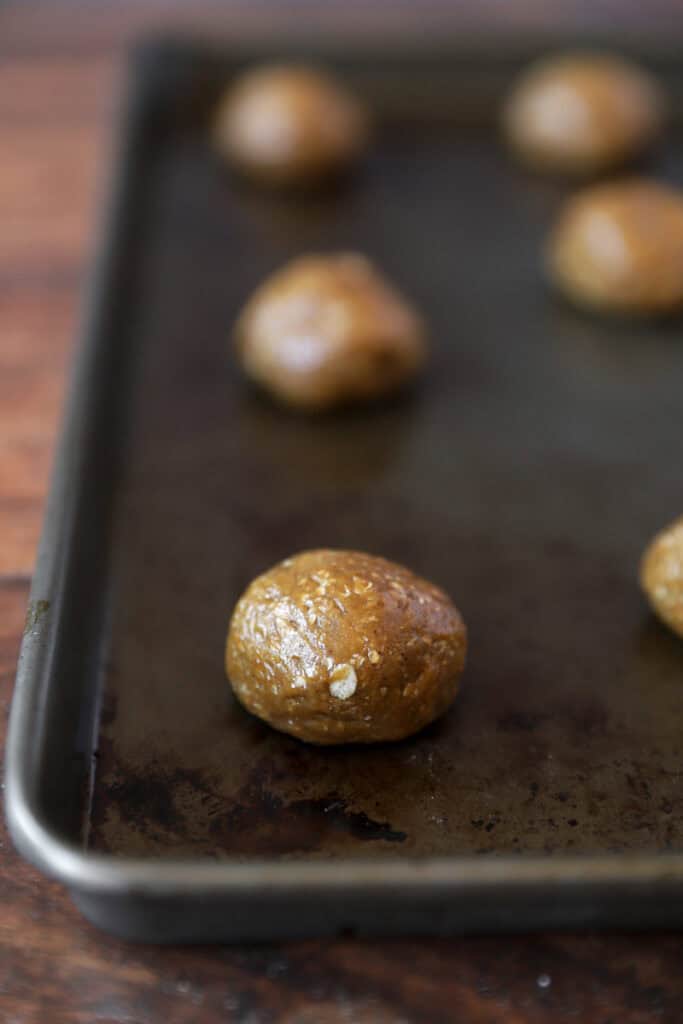 oatmeal cookie dough balls unbaked on the baking sheet.