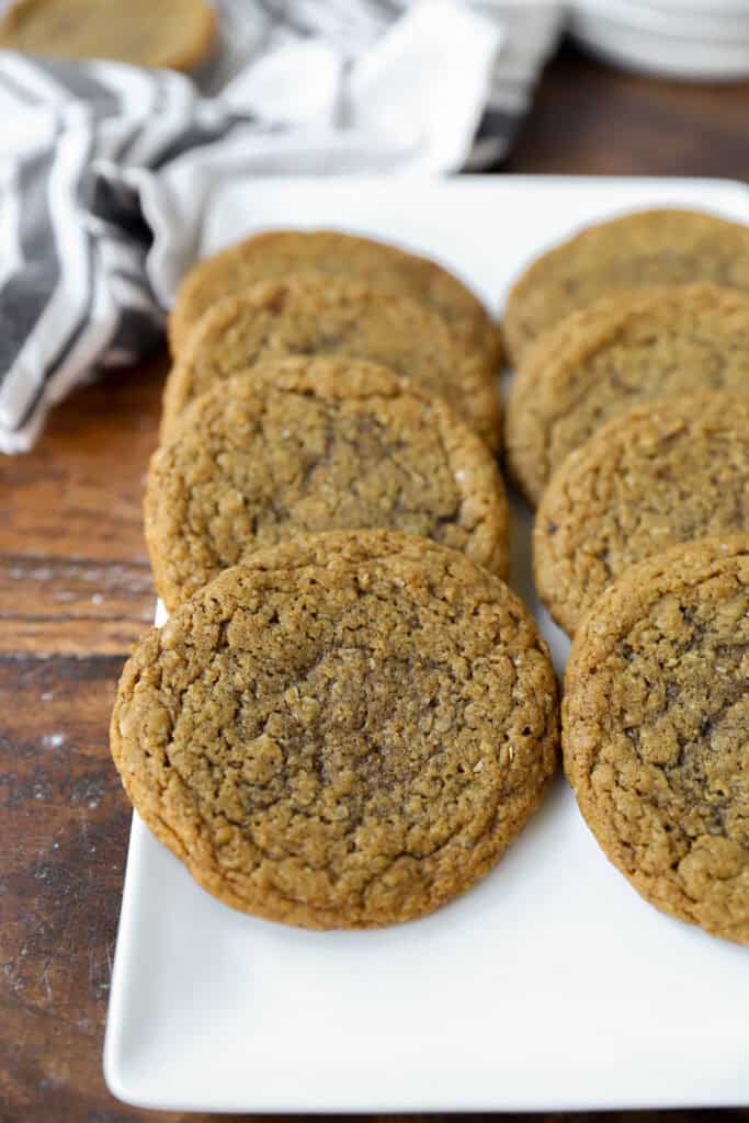 thin oatmeal cookies on a white platter.